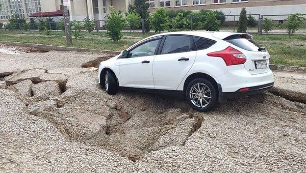 Машина на разрушившемся участке дороги