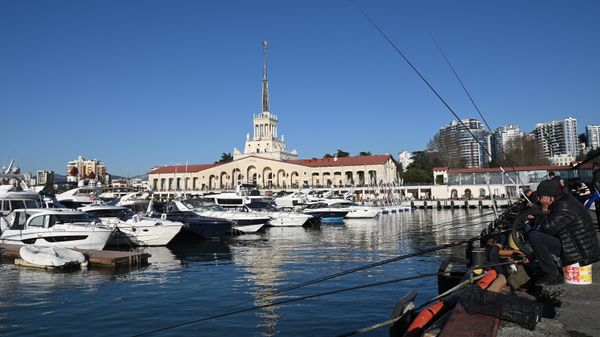 Рыбаки на пирсе и морской вокзал в Центральном районе города Сочи