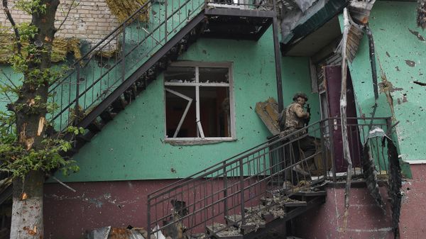 Боец ЧВК Вагнер заходит в разрушенный дом в Артемовске
