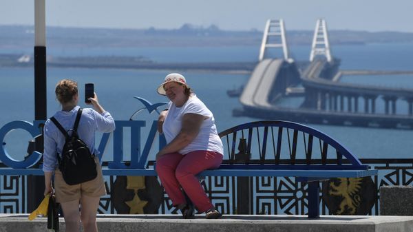 Отдыхающие фотографируются на фоне Крымского моста