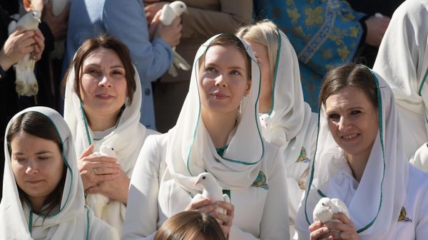 Девушки выпускают голубей после божественной литургии в Благовещенском соборе Московского Кремля в праздник Благовещения Пресвятой Богородицы