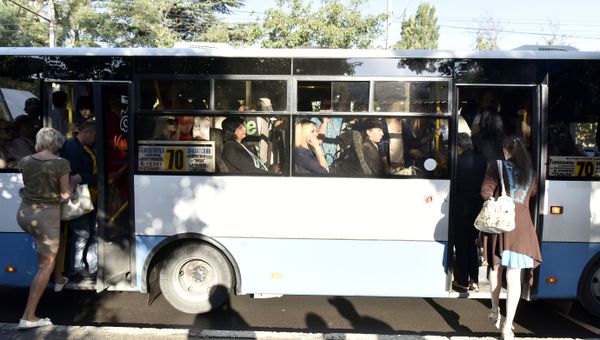 Люди заходят в переполненный автобус на остановке в Симферополе Люди заходят в переполненный автобус на остановке в Симферополе