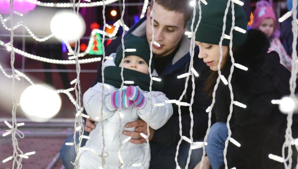 Семья среди новогодних композиций на площади Ленина в Симферополе
