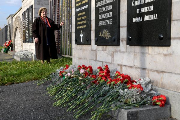 Цветы на Пискаревском мемориальном кладбище у доски памяти жителей Крымского полуострова в блокадном Ленинграде, принесенные жителями Санкт-Петербурга в память о погибших при нападении на колледж в Керчи