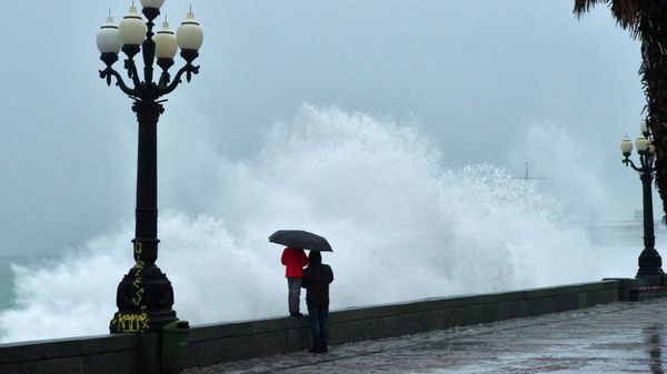 Люди на набережной Ялты во время шторма на Черном море