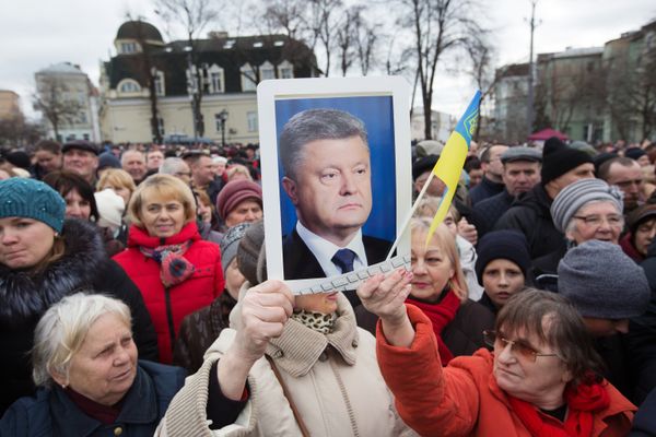 Люди слушают предвыборную речь президента Украины Петра Порошенко на Михайловской площади в Киеве